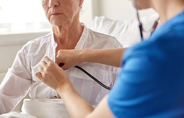 Image showing doctor with stethoscope and old woman at hospital