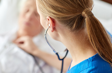 Image showing doctor with stethoscope and old woman at hospital