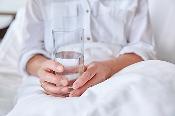 Image showing close up of senior woman with water at hospital