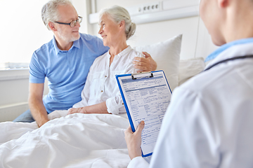 Image showing old couple and doctor with clipboard at hospital