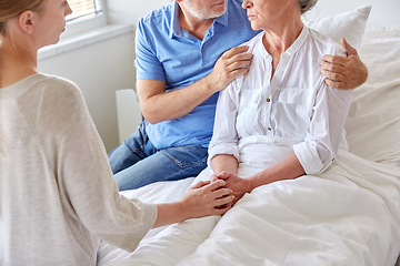 Image showing family visiting senior woman at hospital