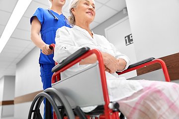 Image showing nurse with senior patient in wheelchair at clinic