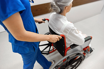 Image showing nurse with senior patient in wheelchair at clinic