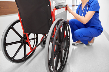 Image showing nurse with senior patient in wheelchair at clinic