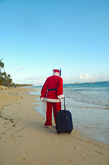 Image showing Santa Claus is on vacation on a tropical beach.