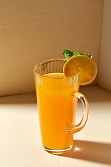 Image showing jug with orange juice and peppermint on table