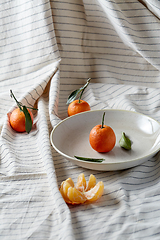 Image showing still life with mandarins on plate over drapery