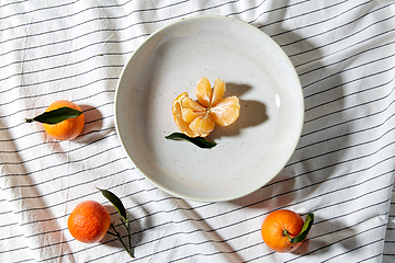 Image showing still life with mandarins on plate over drapery