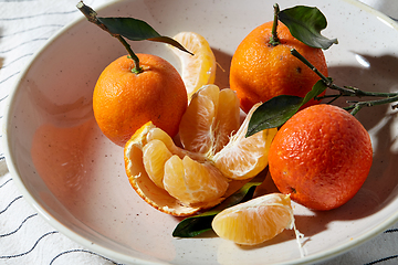 Image showing still life with mandarins on plate over drapery