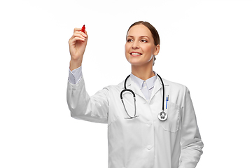 Image showing happy female doctor writing with red marker