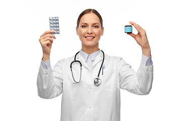 Image showing smiling female doctor holding medicine pills