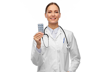 Image showing smiling female doctor holding medicine pills