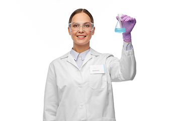 Image showing female scientist in goggles with chemical in flask