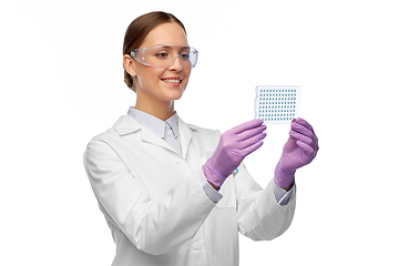 Image showing female scientist in goggles with chemical sample