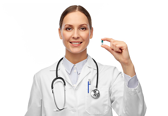 Image showing smiling female doctor holding medicine pill