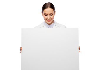 Image showing happy smiling female doctor holding white board