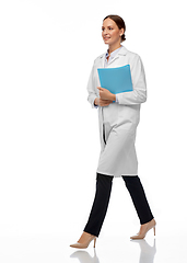 Image showing female doctor or scientist walking with folder