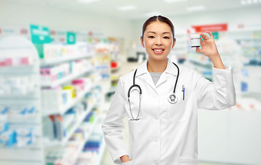 Image showing asian female doctor with medicine at pharmacy