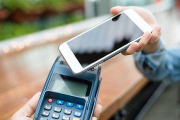 Image showing Woman using cellphone for payment by NFC technology