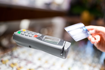 Image showing Woman paying with NFC technology on credit card