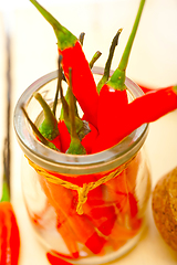 Image showing red chili peppers on a glass jar