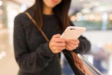 Image showing Woman working on cellphone in shopping mall