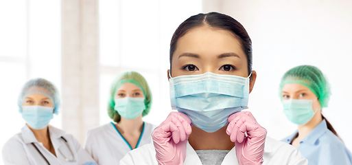 Image showing asian female doctor in medical mask and gloves