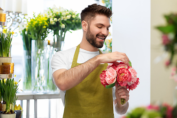 Image showing smiling male florist or seller at flower shop