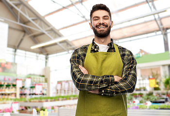 Image showing happy male gardener or seller at flower shop