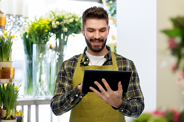 Image showing florst or seller with tablet pc at flower shop