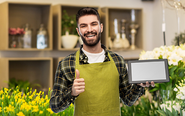 Image showing flower seller with tablet pc shows thumbs up