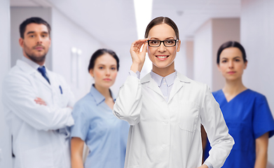 Image showing smiling female doctor with colleagues at hospital