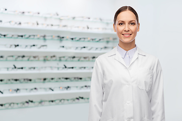 Image showing happy smiling female doctor at optical store