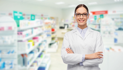 Image showing happy female pharmacist or doctor over pharmacy