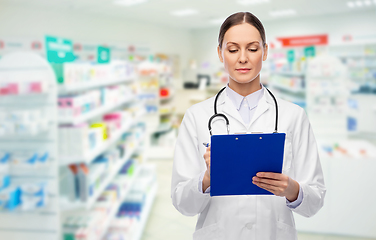 Image showing doctor with clipboard and stethoscope at pharmacy