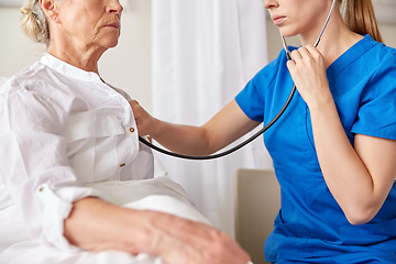 Image showing doctor with stethoscope and old woman at hospital