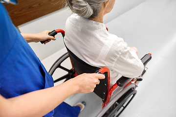 Image showing nurse with senior patient in wheelchair at clinic