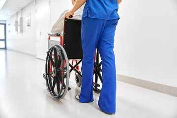 Image showing nurse with senior patient in wheelchair at clinic