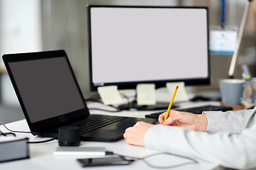 Image showing businesswoman with notebook and laptop at office