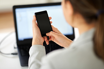 Image showing businesswoman with smartphone working at office