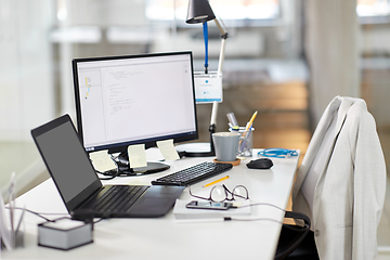 Image showing laptop computer and gadgets on table at office