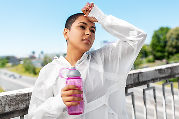 Image showing african american woman drinking water from bottle