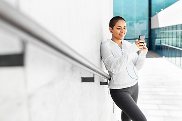 Image showing african american woman with earphones and phone