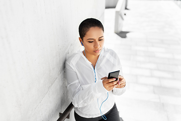 Image showing african american woman with earphones and phone