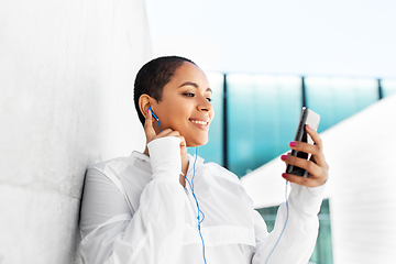 Image showing african american woman with earphones and phone