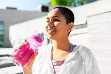 Image showing african american woman drinking water from bottle