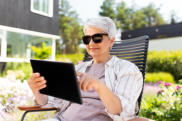 Image showing happy senior woman with tablet pc at summer garden