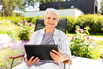 Image showing happy senior woman with tablet pc at summer garden