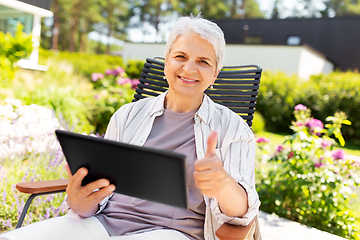 Image showing happy senior woman with tablet pc at summer garden