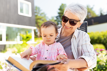 Image showing grandmother and baby granddaughter reading book